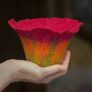 Image of a hand holding a felted tulip shaped bowl