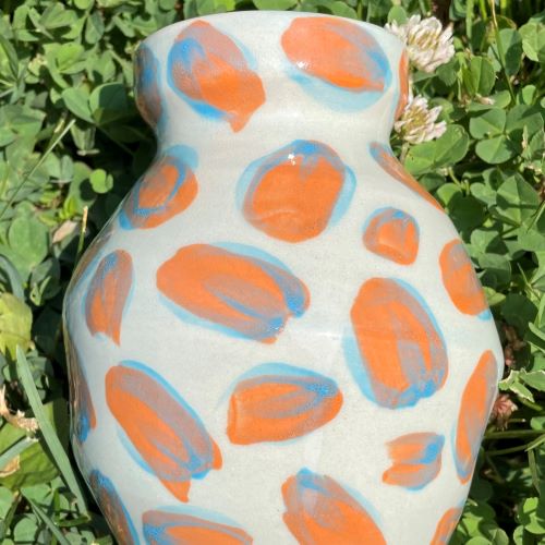 Image of a vase with orange spots